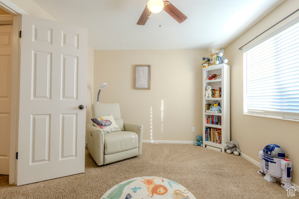 Playroom featuring carpet floors, a ceiling fan, and baseboards