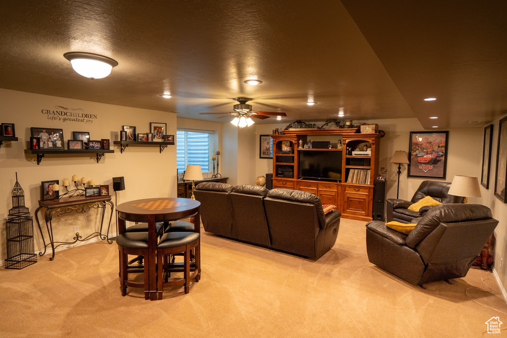 Living room with light colored carpet, a ceiling fan, and recessed lighting