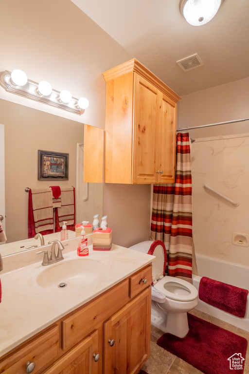 Full bathroom with visible vents, shower / bath combination with curtain, toilet, and vanity