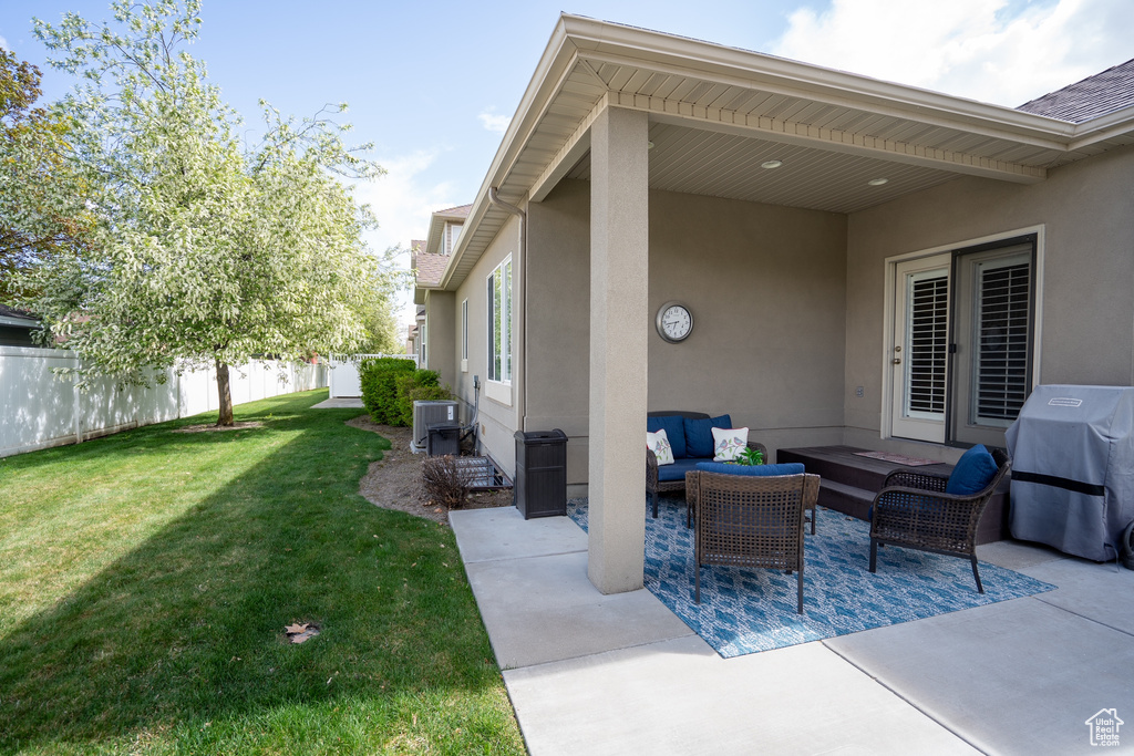 View of patio featuring an outdoor living space, central AC, fence, and area for grilling