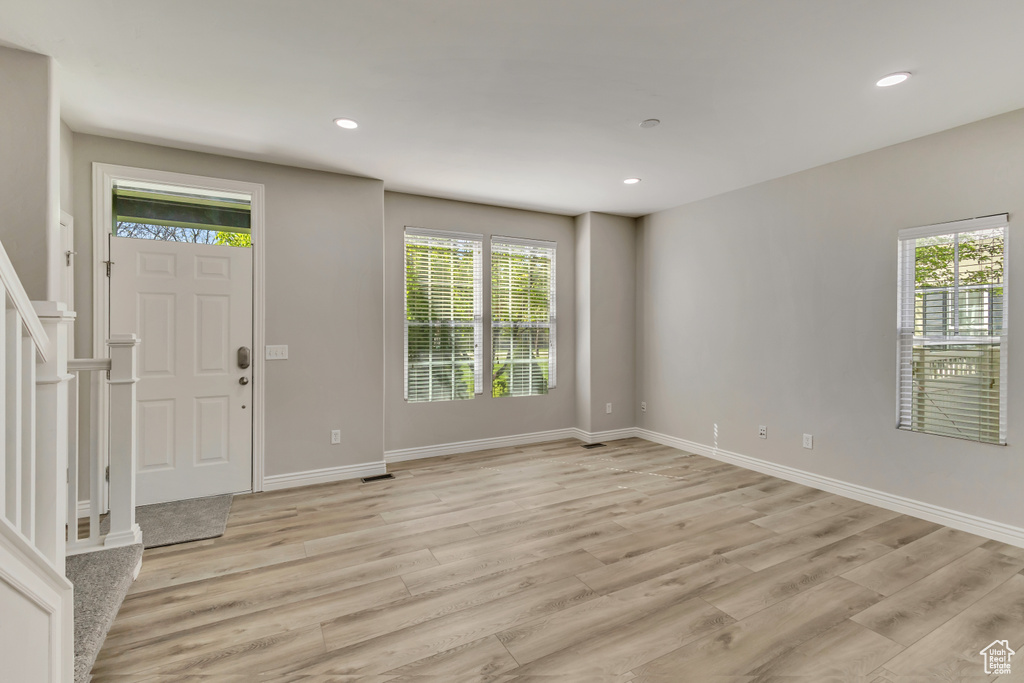 Foyer with recessed lighting, light wood-style flooring, and baseboards