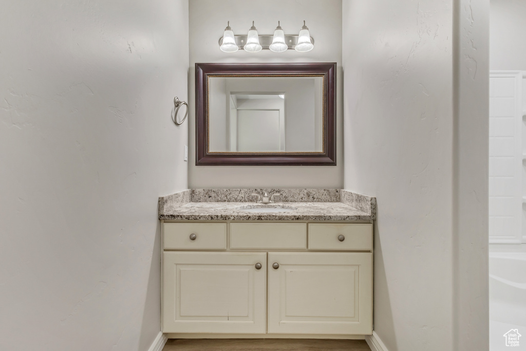 Bathroom with vanity and baseboards