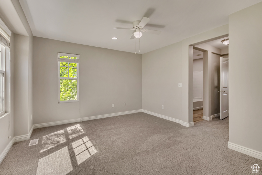 Interior space featuring baseboards, visible vents, and ceiling fan