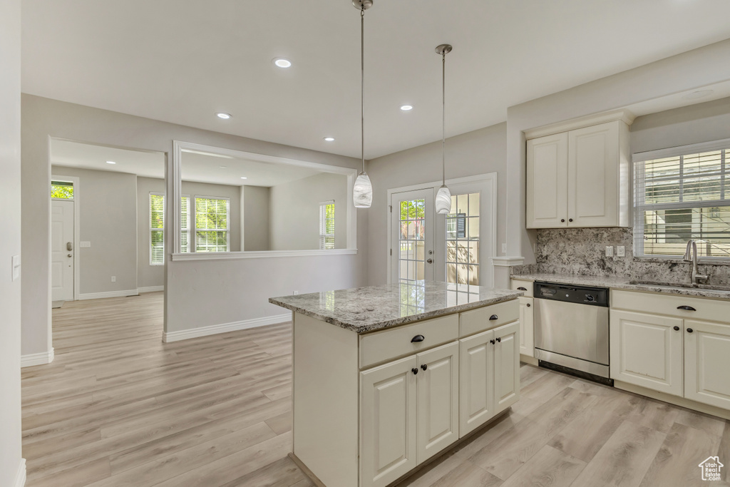 Kitchen with stainless steel dishwasher, recessed lighting, a sink, and light wood-type flooring