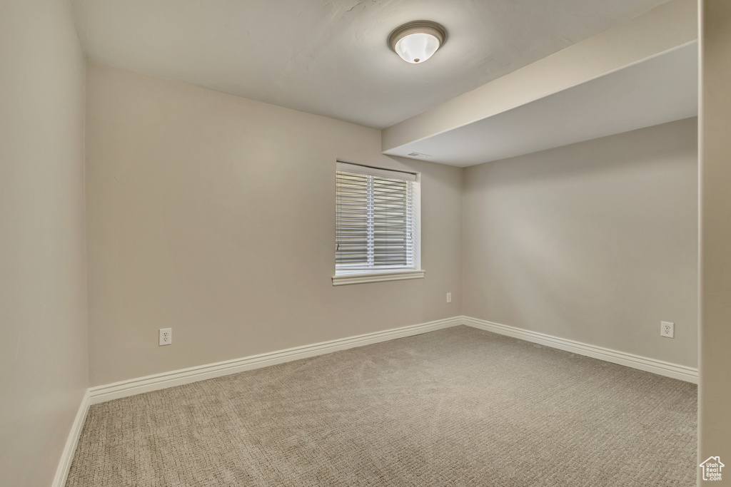 Unfurnished room with carpet flooring and baseboards