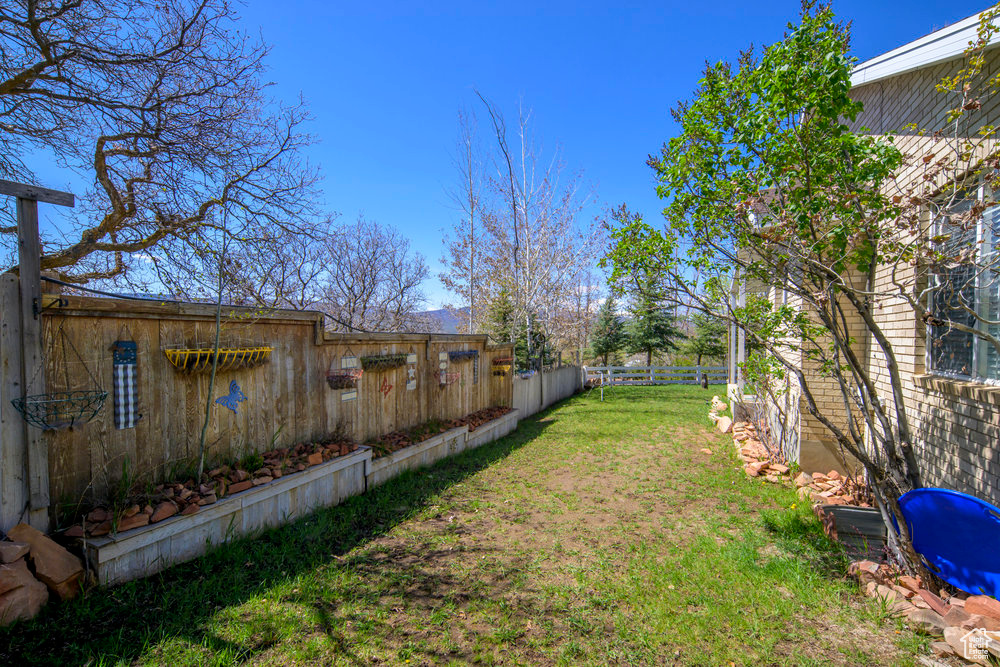 View of yard featuring fence