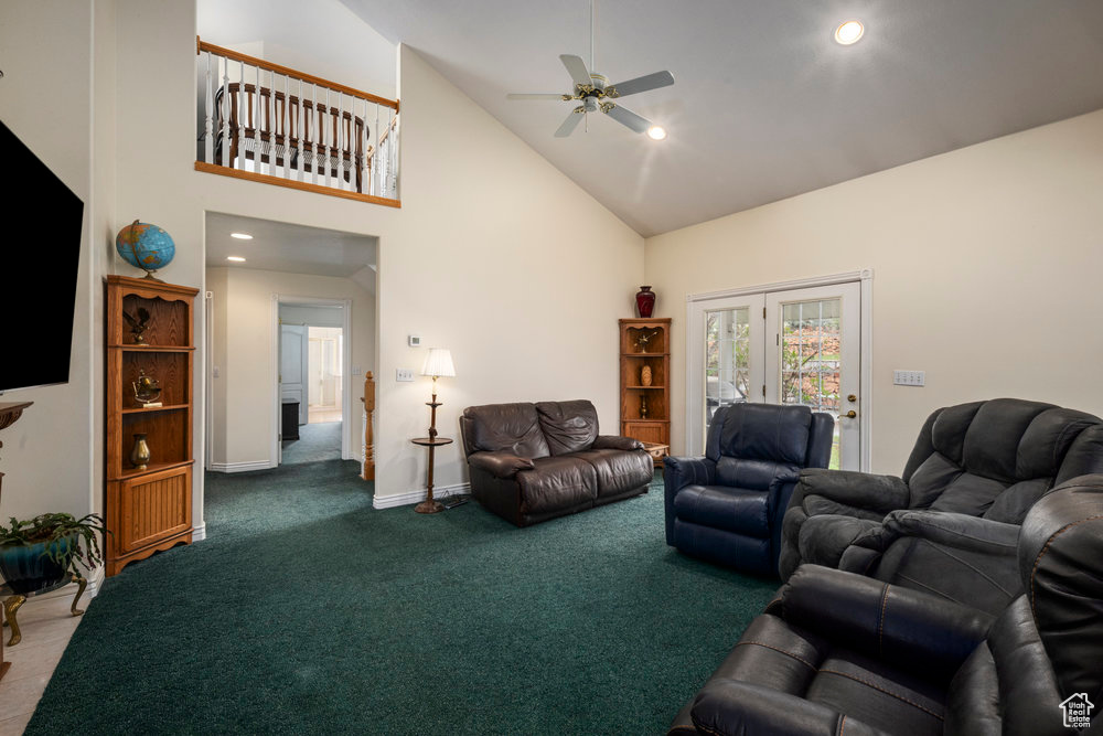 Carpeted living room with baseboards, a ceiling fan, recessed lighting, and high vaulted ceiling