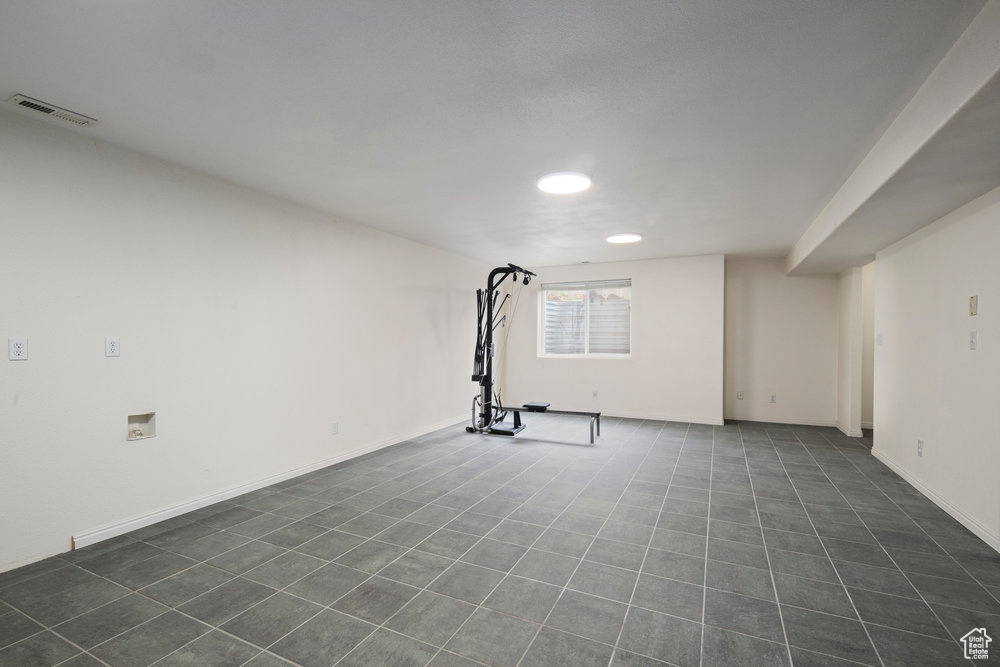 Exercise room featuring recessed lighting, visible vents, and dark tile patterned floors