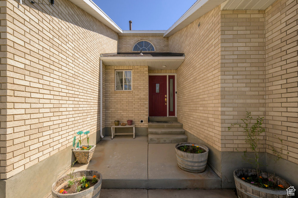 Doorway to property with brick siding