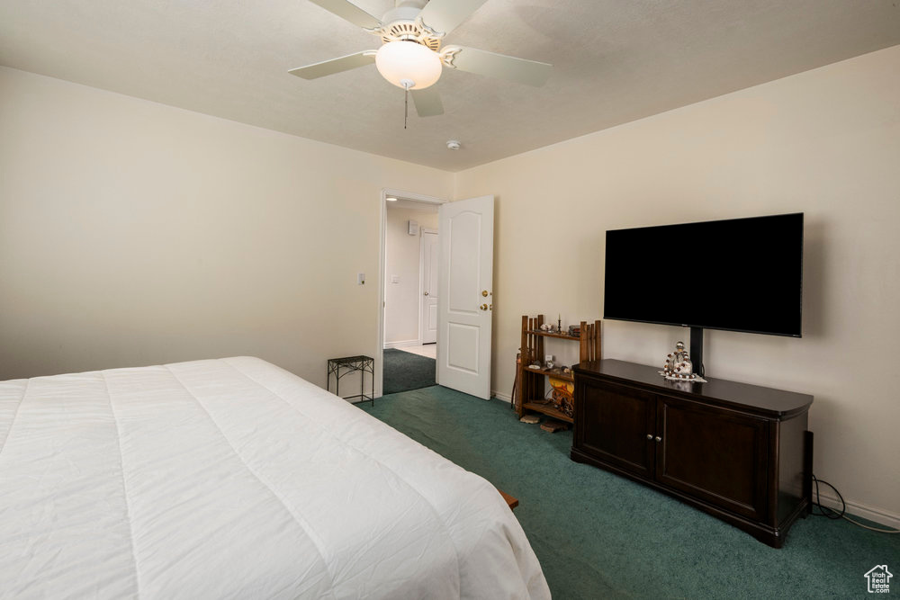 Bedroom featuring carpet floors, a ceiling fan, and baseboards