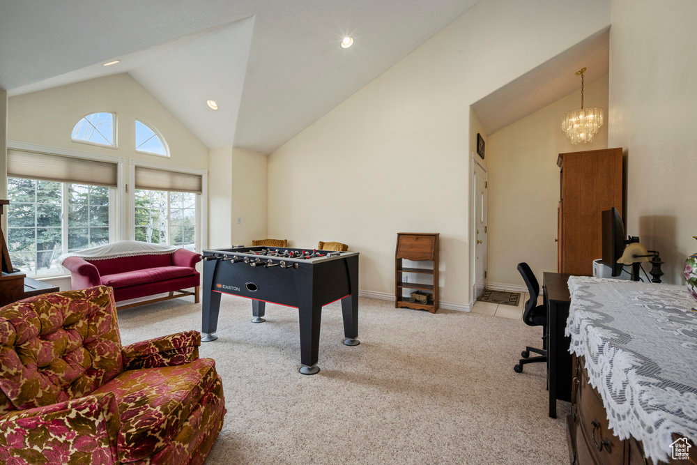 Playroom featuring carpet floors, recessed lighting, a chandelier, and high vaulted ceiling