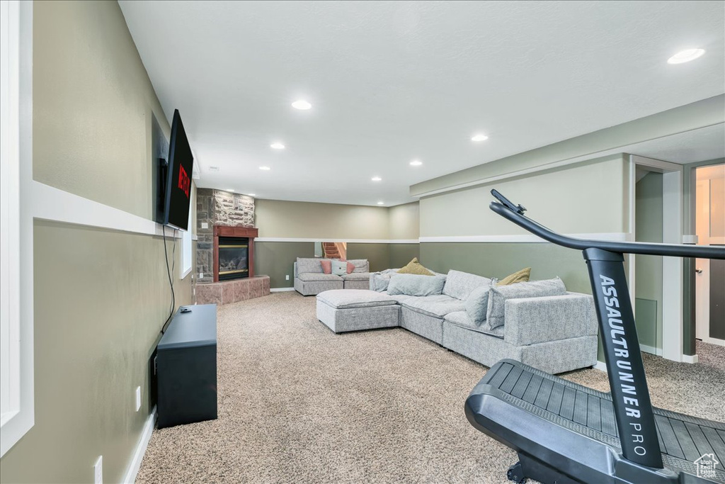 Living room featuring carpet floors, recessed lighting, baseboards, and a large fireplace