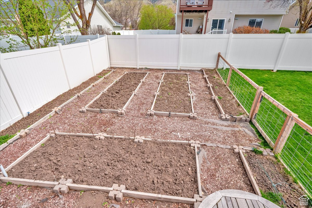 View of yard with a fenced backyard and a garden