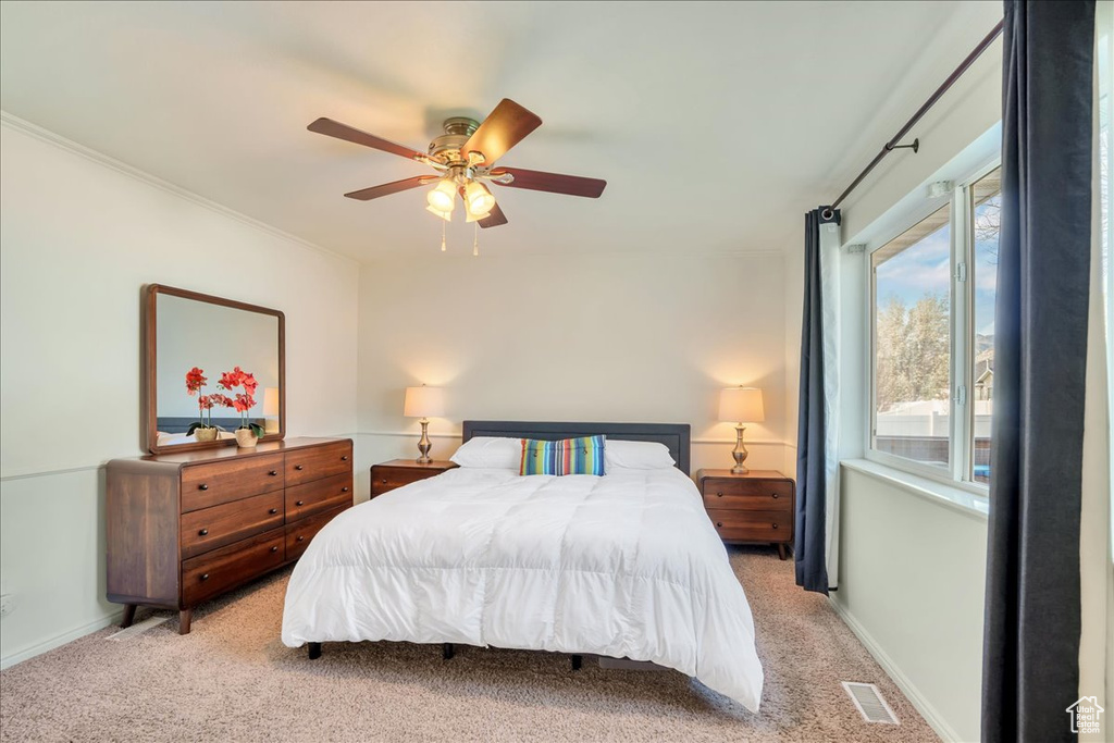 Bedroom with visible vents, a ceiling fan, carpet, and baseboards