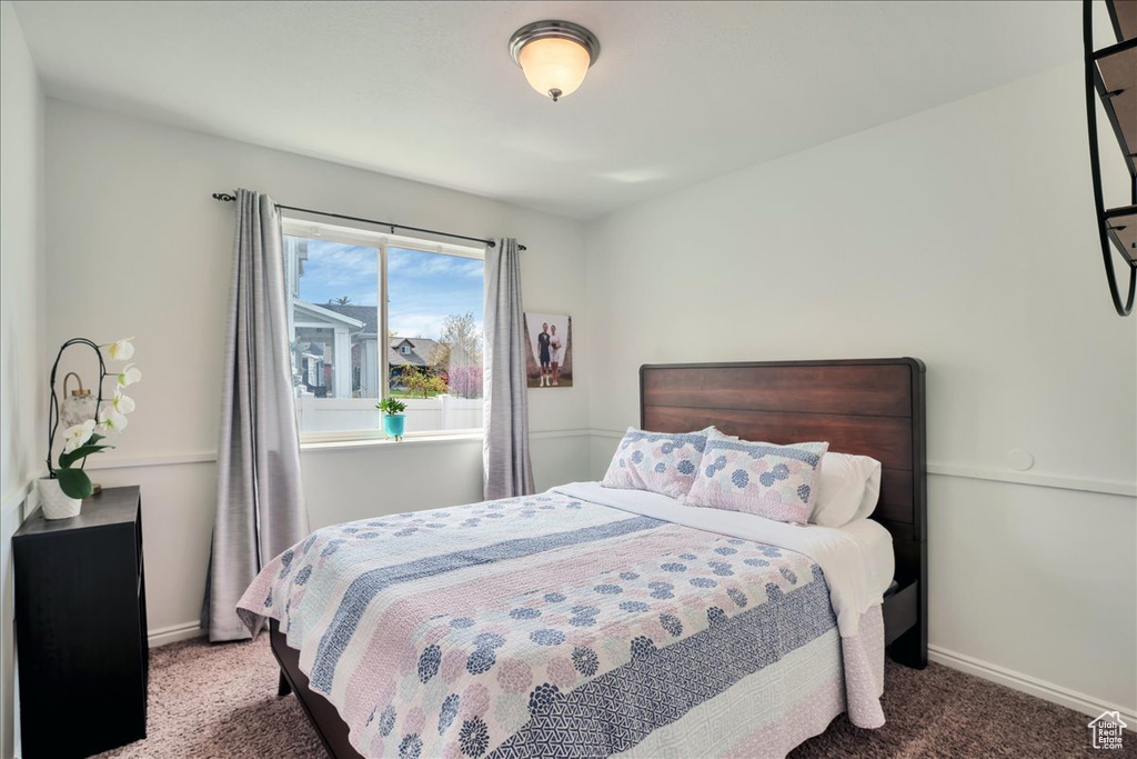 Bedroom featuring baseboards and carpet flooring