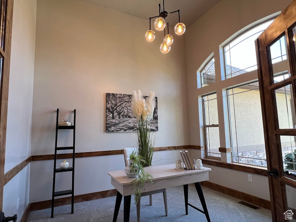Home office featuring carpet floors, baseboards, and visible vents