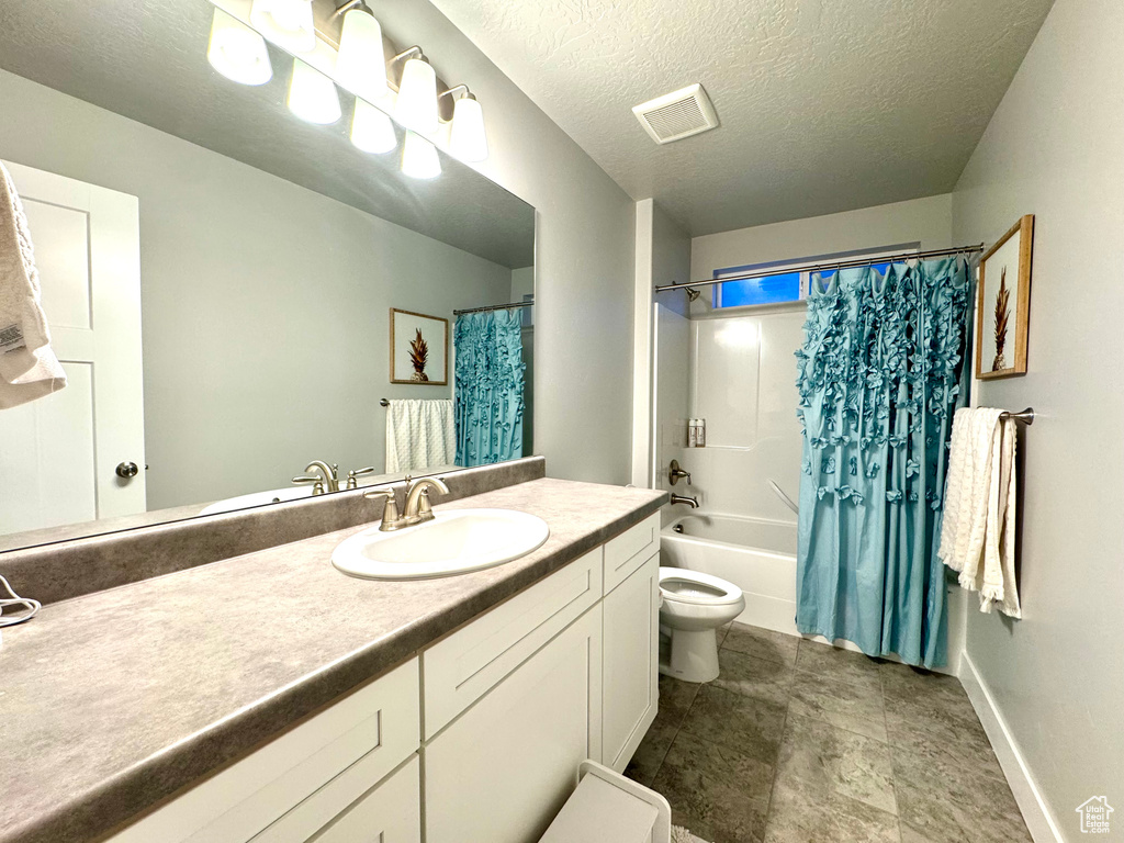 Bathroom with visible vents, vanity, baseboards, toilet, and shower / bathtub combination with curtain