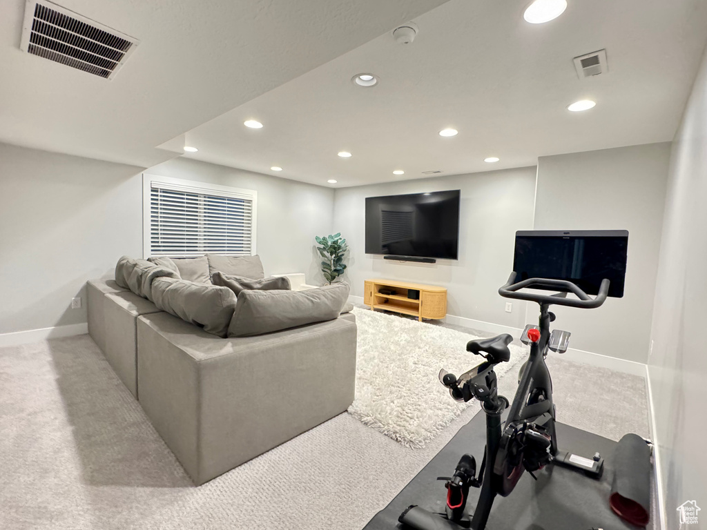 Carpeted living area featuring visible vents, recessed lighting, and baseboards