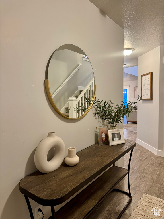 Details with a textured ceiling and wood finished floors