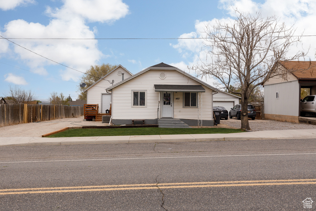Bungalow-style home with crawl space, fence, and an outdoor structure