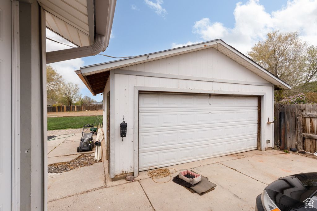Detached garage featuring fence