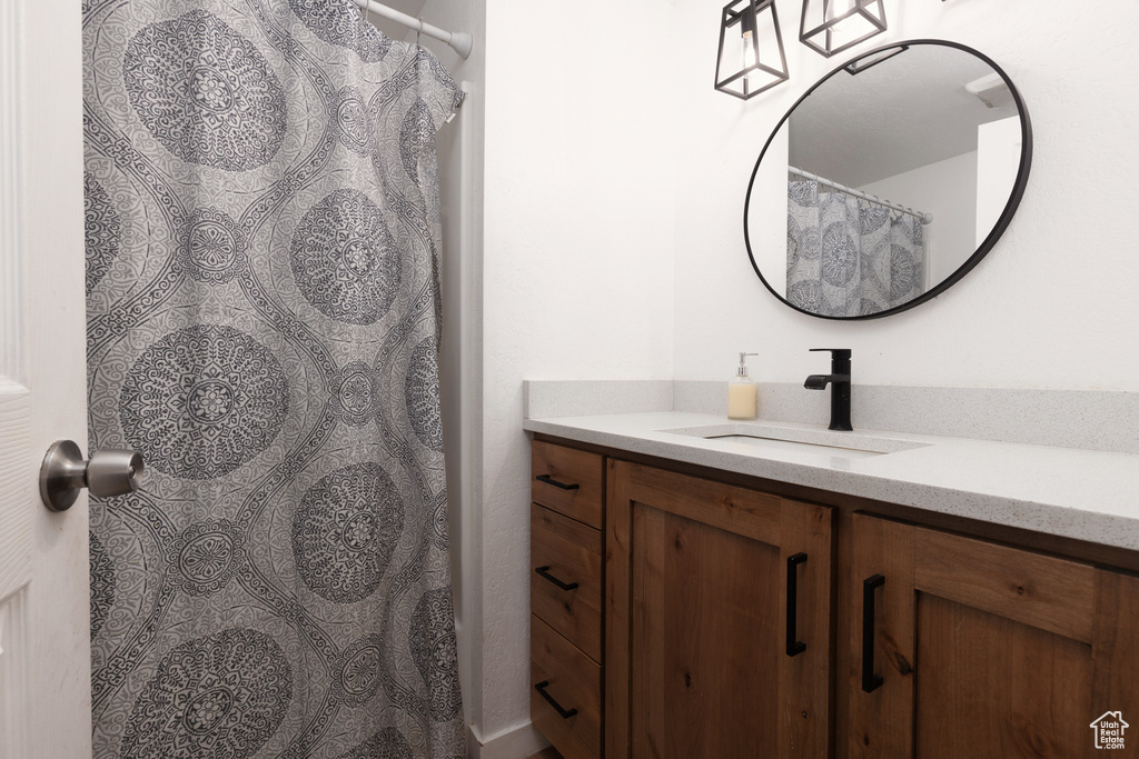 Full bathroom featuring vanity and curtained shower