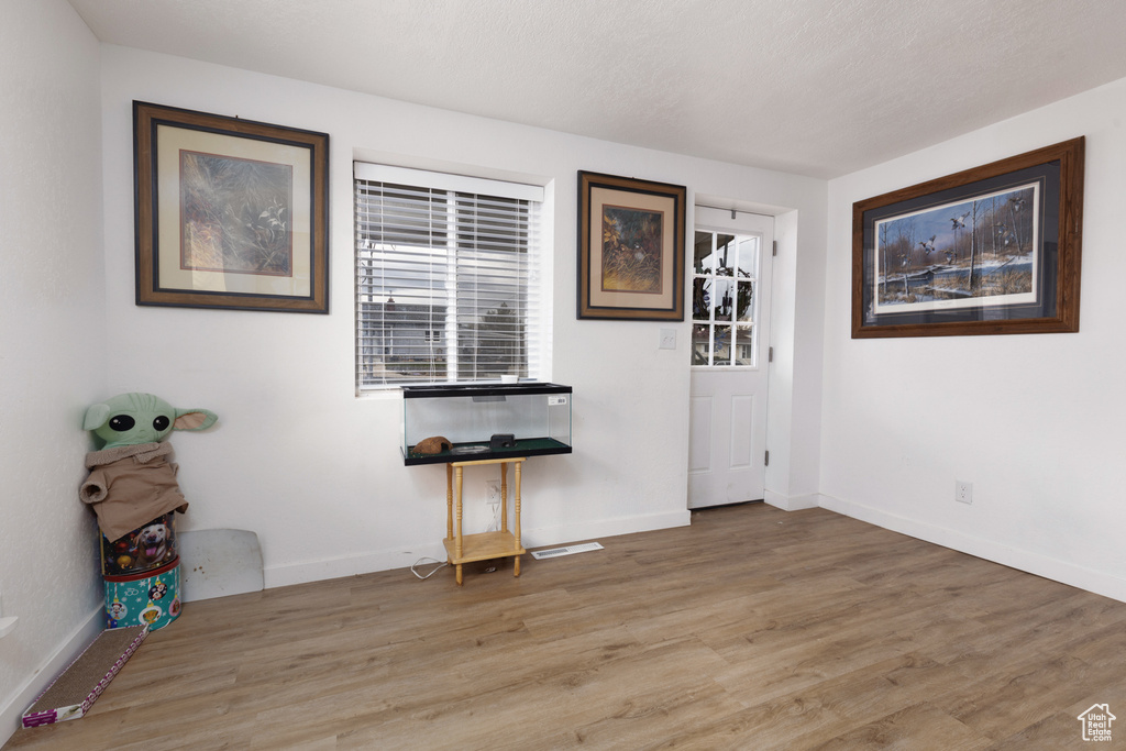 Interior space featuring baseboards and light wood-type flooring