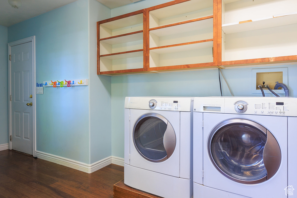 Laundry room with baseboards, laundry area, independent washer and dryer, and wood finished floors