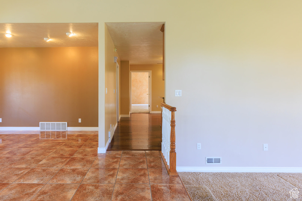 Unfurnished room with visible vents and baseboards