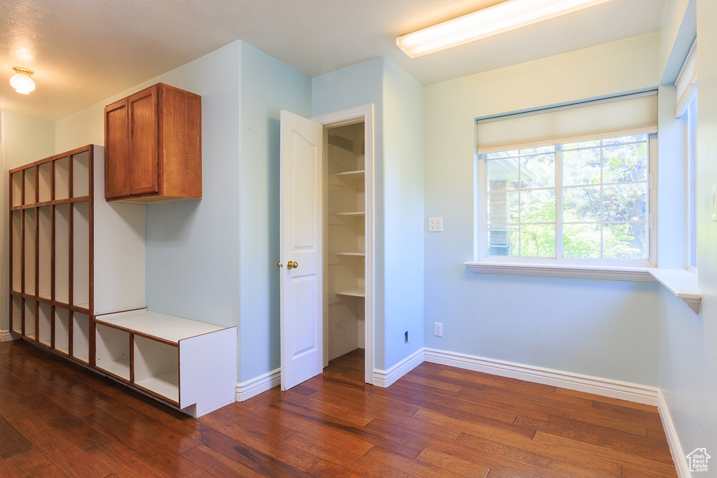 Interior space featuring baseboards and dark wood finished floors