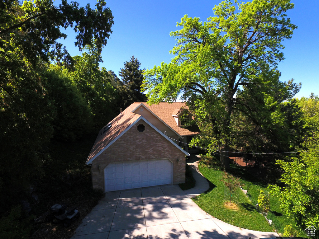 View of front of property featuring brick siding and concrete driveway
