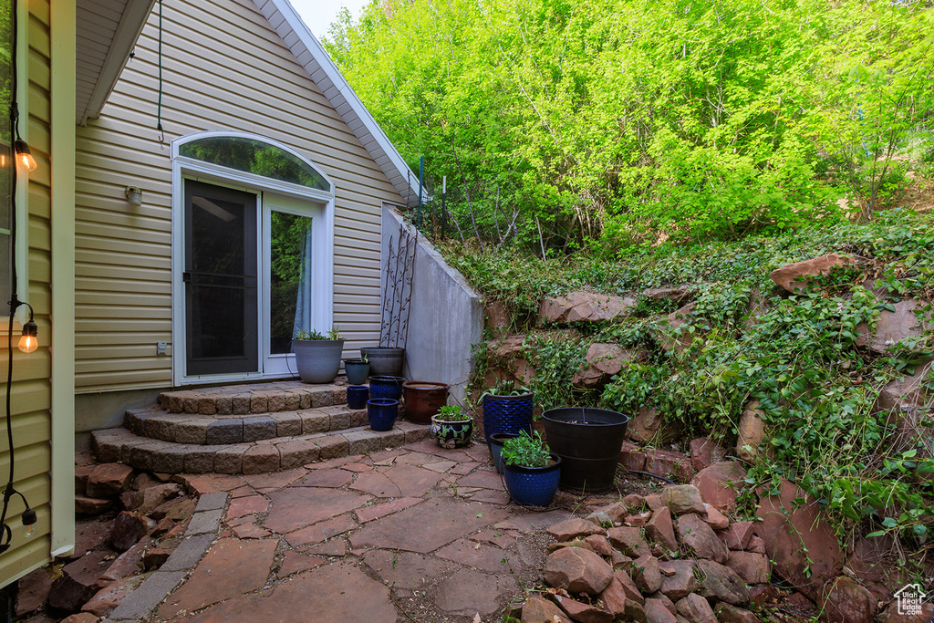 Doorway to property with a patio and fence