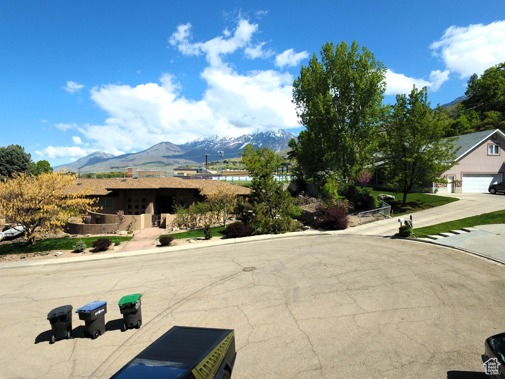 View of road featuring curbs, a mountain view, and sidewalks