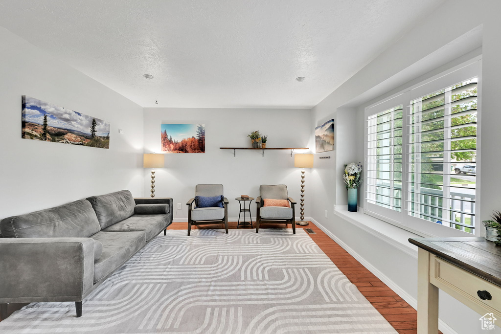 Living area featuring baseboards and wood finished floors