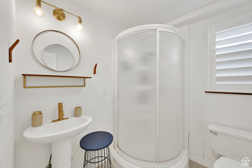 Full bath featuring toilet and a shower stall