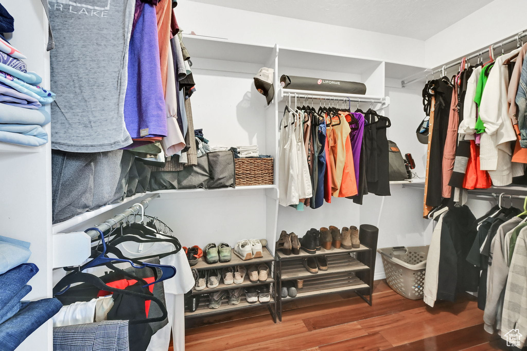 Walk in closet with wood finished floors