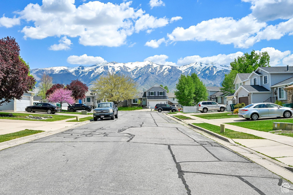 View of road featuring sidewalks, a residential view, a mountain view, and curbs