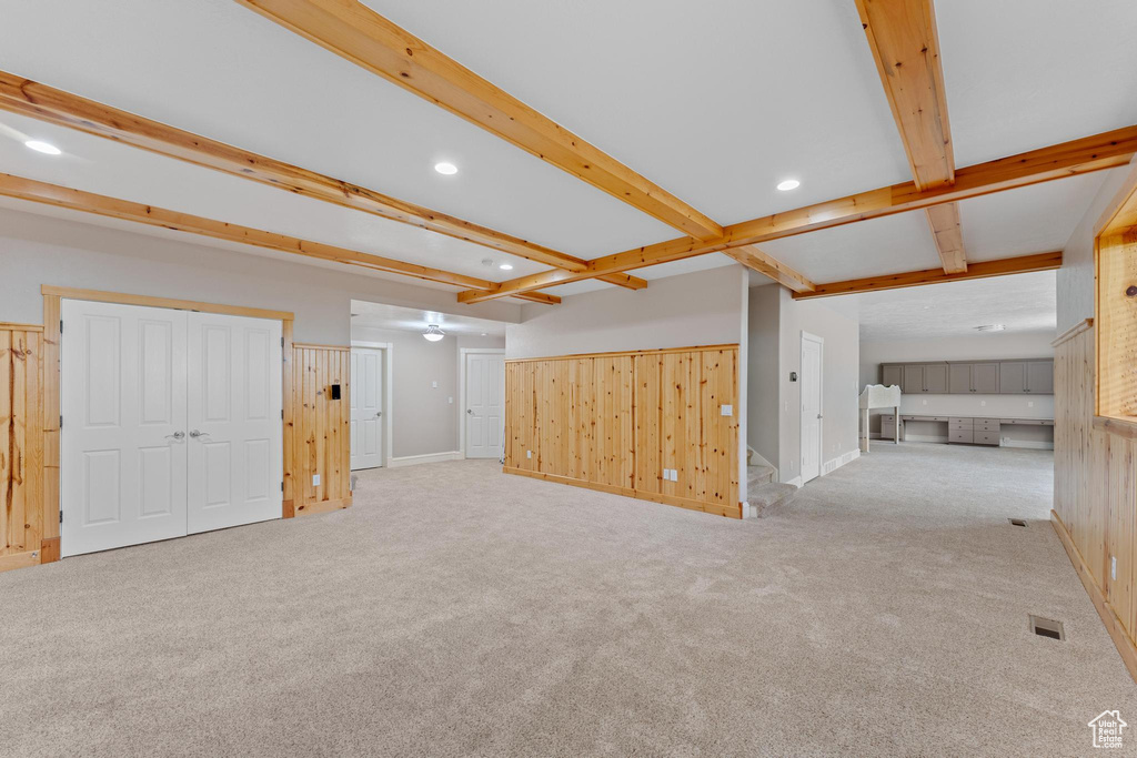 Interior space with stairs, beam ceiling, baseboards, recessed lighting, and carpet