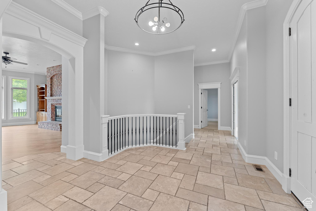 Hallway with visible vents, baseboards, an upstairs landing, recessed lighting, and stone tile floors
