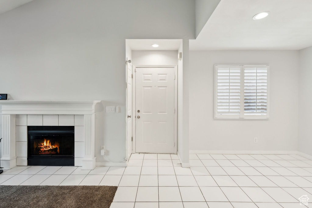 Tiled foyer with baseboards, recessed lighting, and a fireplace
