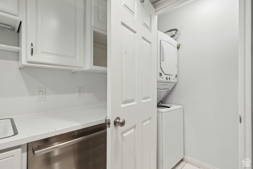 Laundry room featuring laundry area and stacked washer and dryer