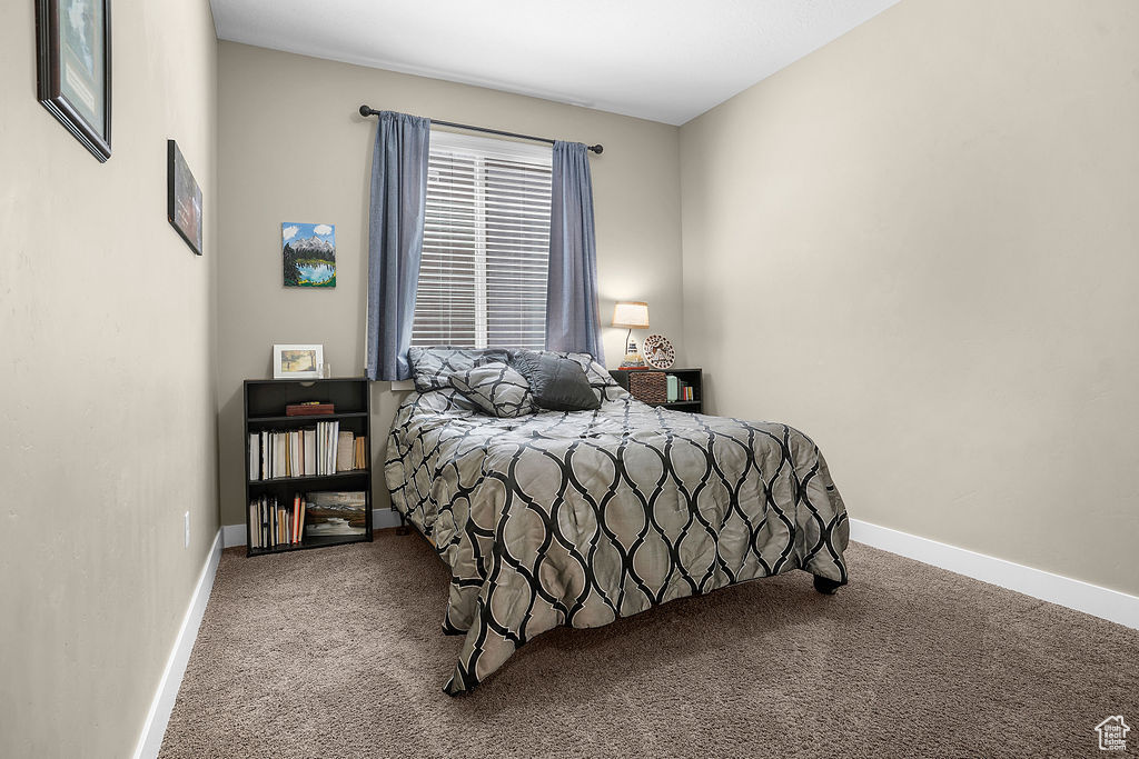 Bedroom with carpet floors and baseboards