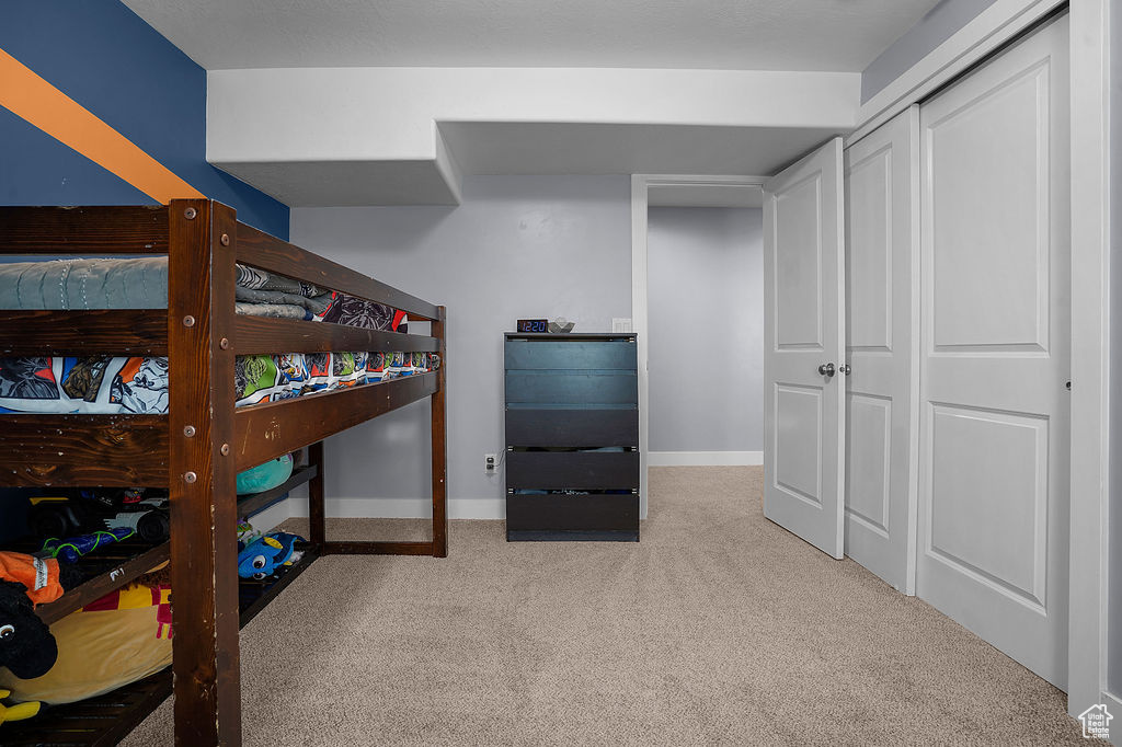 Carpeted bedroom featuring baseboards