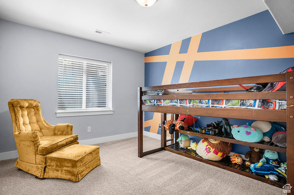 Carpeted bedroom featuring baseboards, lofted ceiling, and visible vents