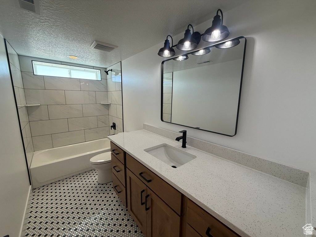 Full bathroom featuring toilet, visible vents, shower / bathing tub combination, and vanity
