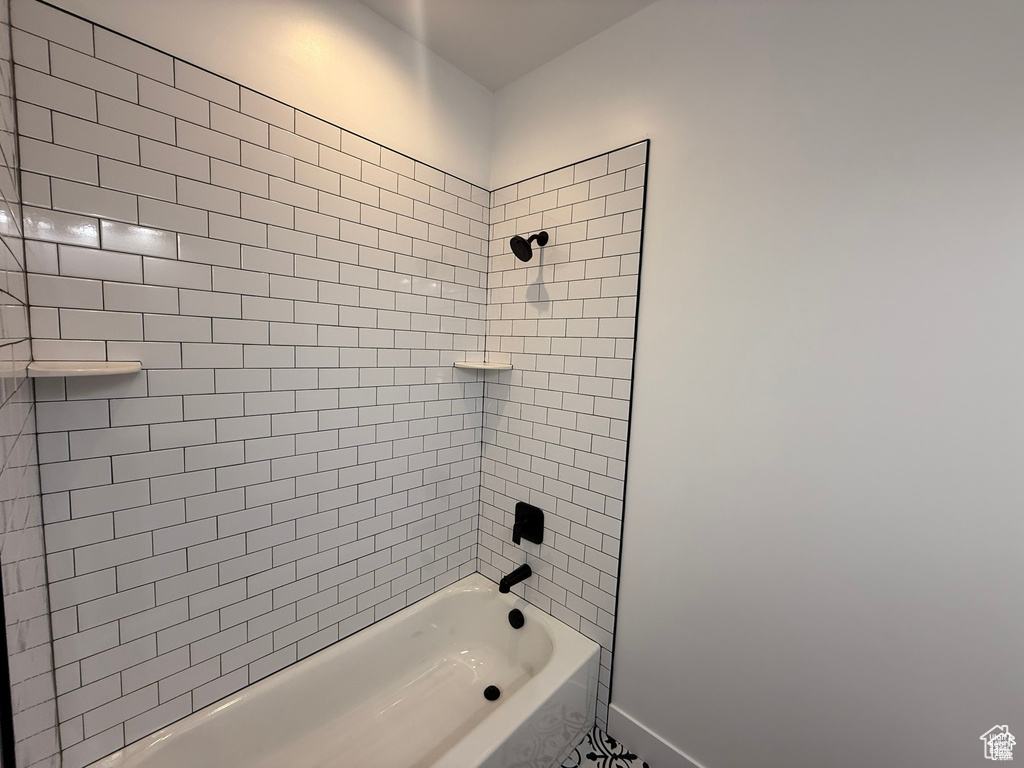 Bathroom with baseboards and shower / washtub combination