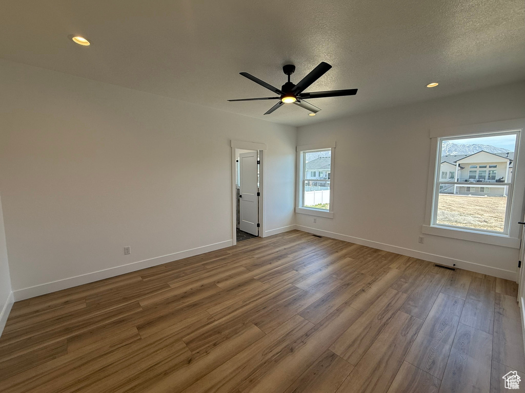 Empty room with baseboards, recessed lighting, ceiling fan, and wood finished floors
