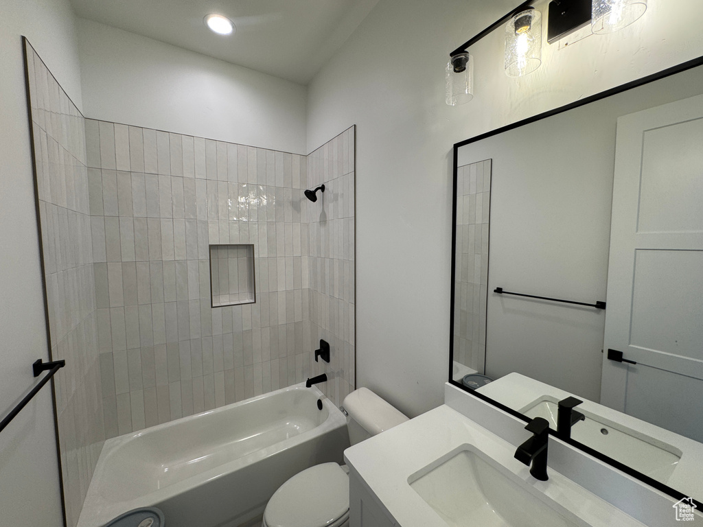 Bathroom with vanity, toilet, and shower / tub combination