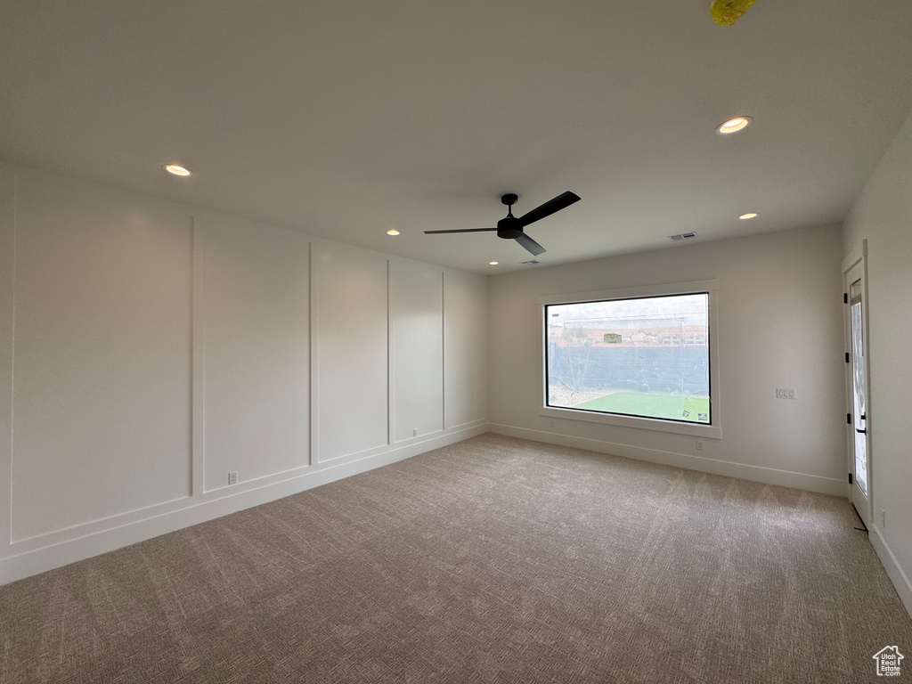 Spare room featuring ceiling fan, light colored carpet, recessed lighting, baseboards, and visible vents