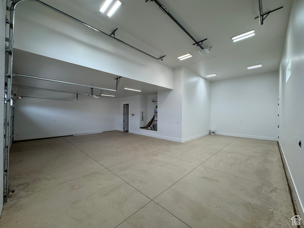 Garage with baseboards and a garage door opener